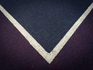 Marking with white paint on the surface of rubber crumb on the sports ground