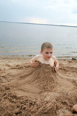 Kid on sandy beach of Lake Seliger