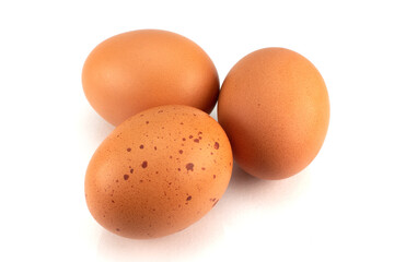 Three brown eggs isolated on white background
