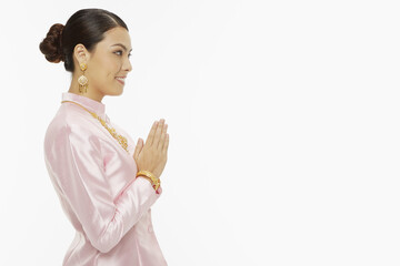 Woman in traditional clothing showing hand greeting gesture