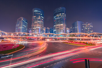 Night view of a crossroad with modern buildings and traffic in Shanghai, China.