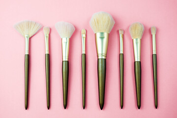 Make up brush on pink background.