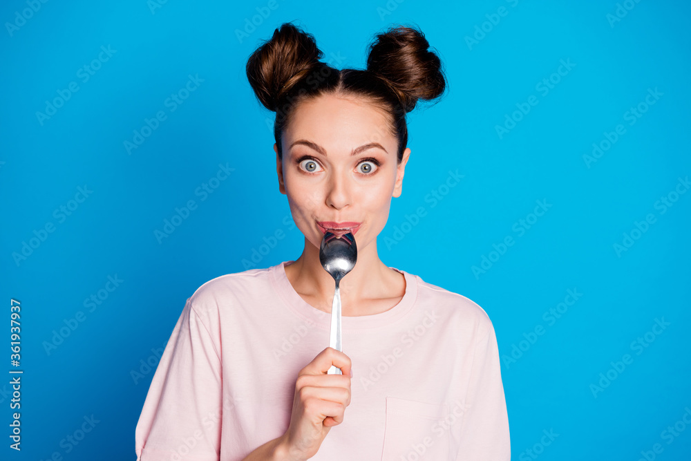 Wall mural Close-up portrait of her she nice attractive pretty cute cheery funny brown-haired girl licking spoon healthy weight loss soup isolated on bright vivid shine vibrant blue color background