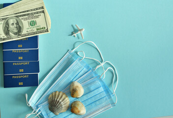 Ukrainian foreign passports and medical masks on blue background.Travel concept on blue background.Canceled vacation travels with COVID-19. Impact of covid-19 on tourism industry.Global quarantine