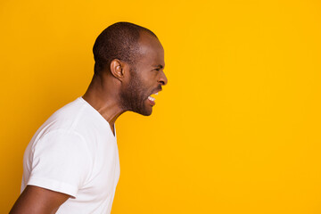 Close-up profile side view portrait of his he devastated crazy fury mad evil wild guy expressing rage isolated over bright vivid shine vibrant yellow color background
