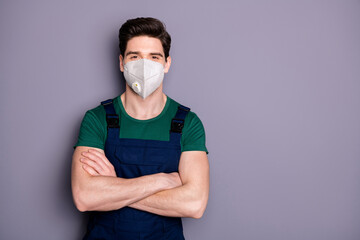 Portrait of his he attractive healthy guy workman wearing safety n95 respirator protective mask contagious mers cov influenza infection prevention folded arms isolated grey color background