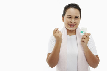 Woman smiling and holding up dental floss