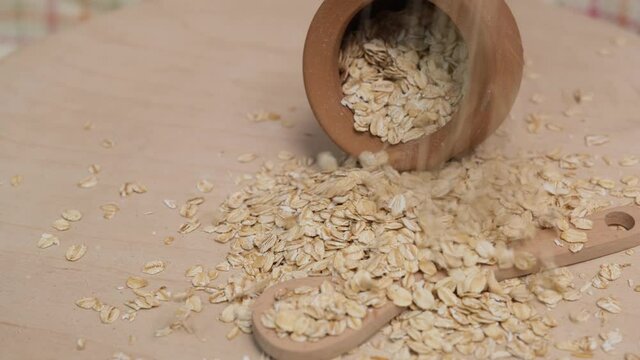 Rolled oats grains in a faience pot. 4k video shot.