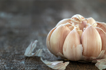 Dried garlic cloves on old wooden table.