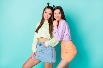 Photo of two pretty sisters lady girlfriends cool youth look clothes hugging good mood wear cropped...