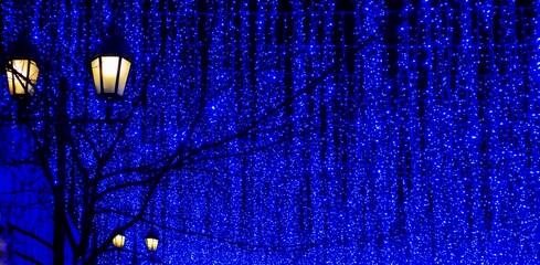 Hanging blue string lights Christmas background 