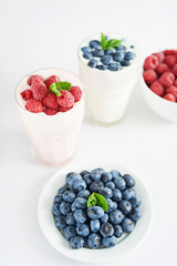 Yogurt cocktail and parfait. Natural detox. Liquid ice cream. Healthy food and breakfast. Good morning. Berry Milk Smoothie with blueberries, strawberries, raspberries. Fresh diet dessert. Summer card
