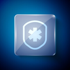 White Medical shield with cross icon isolated on blue background. Protection, safety, password security. Square glass panels. Vector Illustration.
