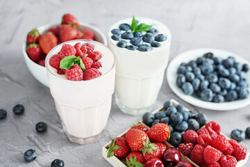 Yogurt cocktail and parfait. Natural detox. Liquid ice cream. Healthy food and breakfast. Good morning. Berry Milk Smoothie with blueberries, strawberries, raspberries. Fresh diet dessert. Summer card