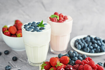 Yogurt cocktail and parfait. Natural detox. Liquid ice cream. Healthy food and breakfast. Good morning. Berry Milk Smoothie with blueberries, strawberries, raspberries. Fresh diet dessert. Summer card