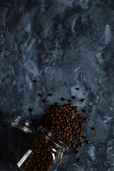 Coffee crumbled from a jar, on a dark concrete background. Copy space.