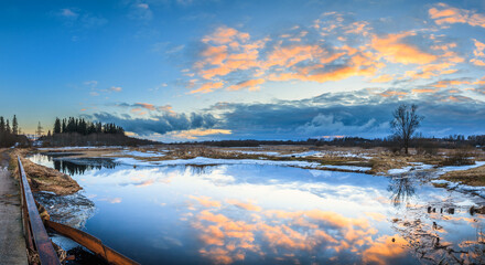 Obraz premium Spring panoramic landscape with river at sunset