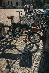 Obraz premium Bicycles on paving stone walkway on urban street of Copenhagen, Denmark