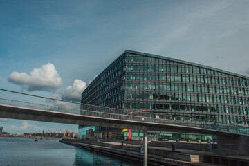 Bridge above river with building and blue sky with clouds at background in Copenhagen, Denmark