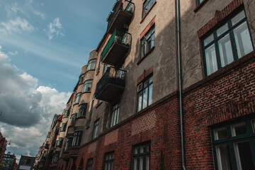 Obraz premium Low angle view of facade of old building with blue sky with clouds at background, Copenhagen, Denmark