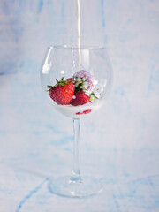 Strawberries in a glass with milk