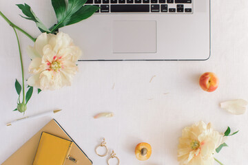 Feminine workspace with laptop, flowers, fashion accessories. Business concept. Flat lay, top view, copy space.