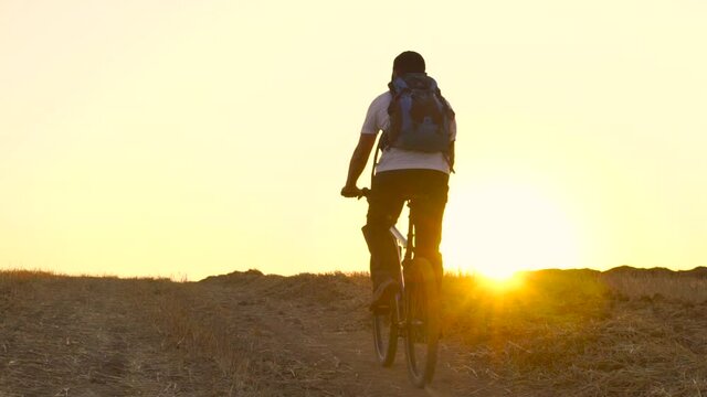 Man Riding Bicycle During Sunset, Outdoors Activity, Sport ,Summer Field - slow motion