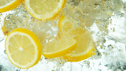 Lemon Slices falling deeply under water on white