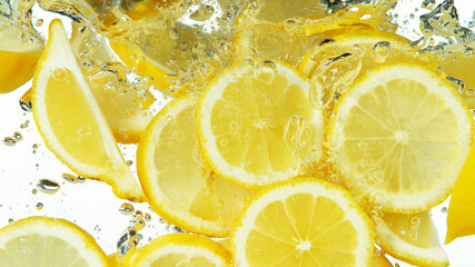 Lemon Slices falling deeply under water on white