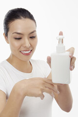 Woman applying lotion on her hand