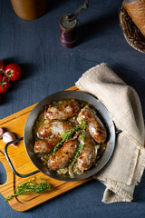 Homemade white sausage fried with onion and herbs