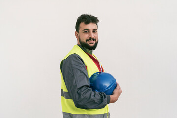 Construction worker portrait on white wall posing