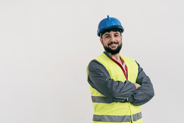 Construction worker portrait on white wall posing