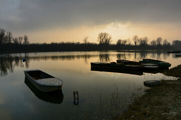 Boats in calm water before the sunset