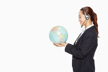Businesswoman with headset holding a globe