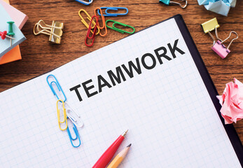 notebook on office table with TEAMWORK text. Business conept