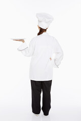 Female chef holding up a tray