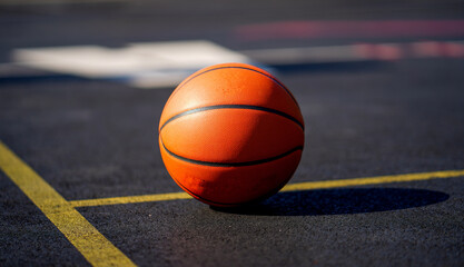 Basketball against dark background of the basketball field