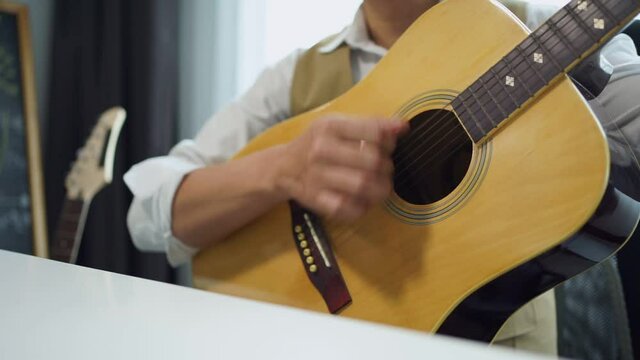 Music teacher hand image with records tutorial video how to play acoustic guitar at home of working at home and online learning, New normal working for social distancing 