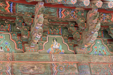 Korean traditional architecture detail of eaves with Guanyin (Goddess of Mercy) image at Bulguksa Temple in Gyeongju, South Korea