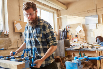 Tischler works as a furniture maker on a workpiece