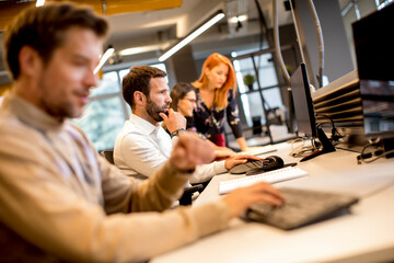 Young professional businessman uses a computer for work in the office