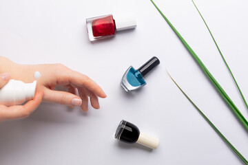 Making manicure at home, applying hand cream on skin. Hands doing cosmetic procedure.