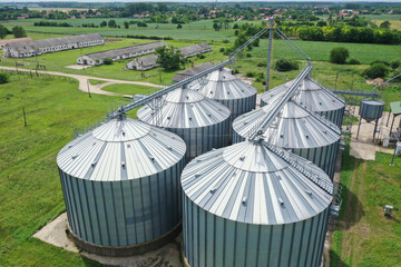 Agricultural silos on the farm, close-ups from above with a drone. Farm Industrial granary, elevator dryer, building exterior, storage and drying of cereals, wheat, corn, soybeans, sunflowers.