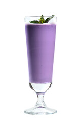 Blueberry milk shake in clear tall glass garnished with mint on white background