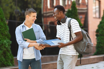 Two Multiethnic College Friends Relaxing Outdoors After Classes