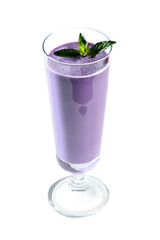 Blueberry milk shake in clear tall glass garnished with mint on white background