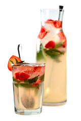 Strawberry tea with pieces of strawberries, ice and mint in a clear glass and a blurred pitcher on a white background