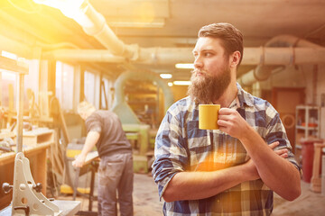 Self-employed hipster carpenter drinking coffee