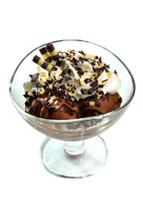 Chocolate ice cream sundae with sweet tubules, whipped cream and chocolate flakes in glass cup on white background